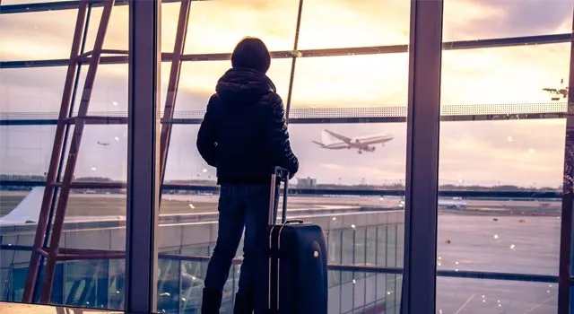 Traveller overlooking an airport runway.